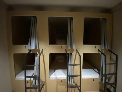 a room with three bunk beds in it at BuenaSentro Hostel in Manila