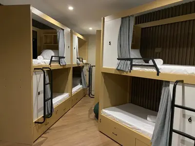 a room with two bunk beds in a dorm room at BuenaSentro Hostel in Manila