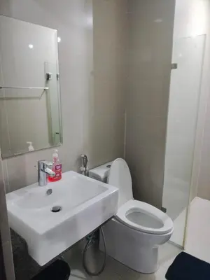 a bathroom with a white sink and a toilet at Rooms Near Airport-Rqui in Manila
