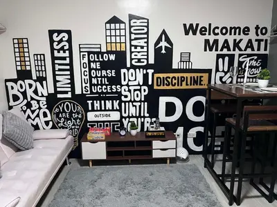 a living room with a black and white wall at Cozy Makati 2BR in CBD Ayala area with games, KTV, and Amazing Pools! in Manila