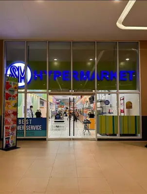 an entrance to a store with a sign on the window at Cozy Makati 2BR in CBD Ayala area with games, KTV, and Amazing Pools! in Manila
