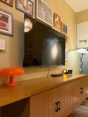 a large flat screen tv hanging on a wall at Serenity Stays at Red Residences in Manila