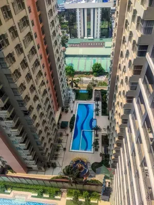 an overhead view of a pool between two buildings at Serenity Stays at Red Residences in Manila