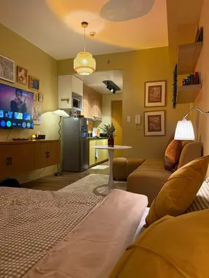 a living room with a couch and a kitchen at Serenity Stays at Red Residences in Manila