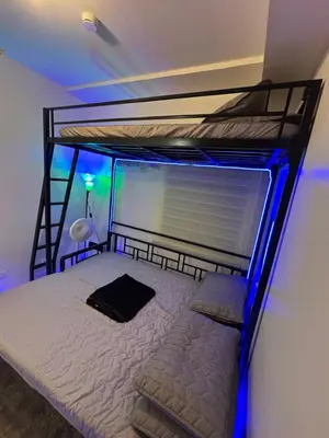 a bedroom with a bunk bed with blue lights at Urban Deca Tower Cubao - Affordable Condo Unit for Transient in Manila