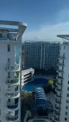 arial view of a building with a pool and a hotel at Azure Staycation by Leojen in Manila