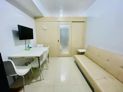 a living room with a couch and a table at Simple Staycay in Manila