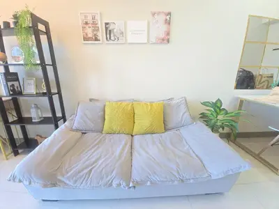 a bed with two yellow pillows in a room at BGC Uptown Parksuites Cosy 1 Bedroom Suite with balcony 300MBPS wifi in Manila