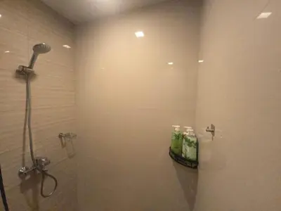 a shower stall in a bathroom with a shower at BGC Uptown Parksuites Cosy 1 Bedroom Suite with balcony 300MBPS wifi in Manila