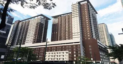 two tall buildings in a city with at 1BR-unit in central BGC in Manila