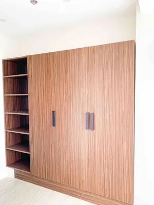 a closet with two wooden doors in a room at 2BR Loft at Fort Victoria Condominium BGC in Manila