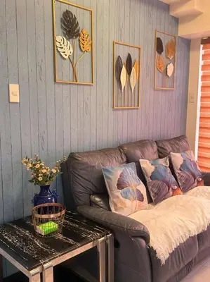 a living room with a couch and a table at torre de manila taft luneta park view in Manila