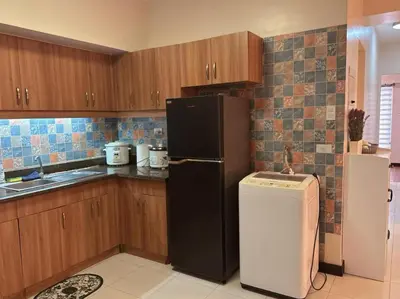 a kitchen with a black refrigerator and a dishwasher at Family Rooms with View in Manila