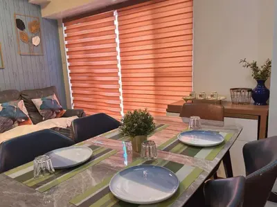 a living room with a table with plates on it at Family Rooms with View in Manila