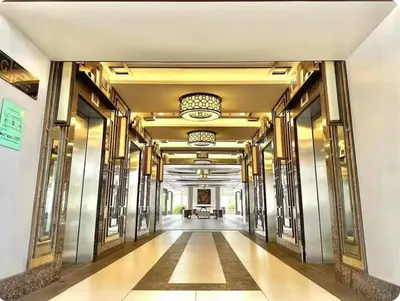a hallway of a building with gold walls and ceilings at Family Rooms with View in Manila