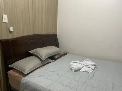 a bed with a white towel on top of it at Shore Residences in Manila