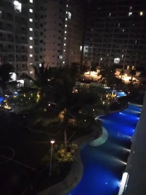 a view of a city at night with blue lights at Shore Residences in Manila