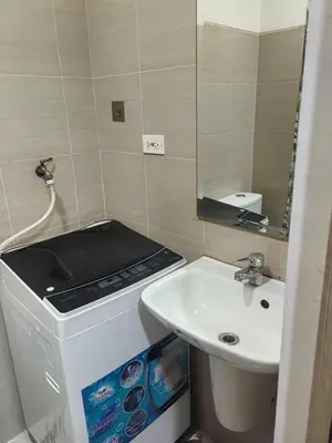 a small bathroom with a sink and a mirror at Staycation in Shore Residences, walking distance to MOA and near Manila Airport in Manila