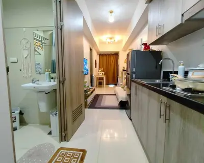 a kitchen with a sink and a counter top at Staycation in Shore Residences, walking distance to MOA and near Manila Airport in Manila