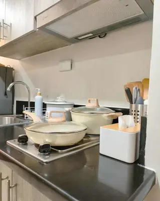 a kitchen with a counter top with some pans on it at Staycation in Shore Residences, walking distance to MOA and near Manila Airport in Manila