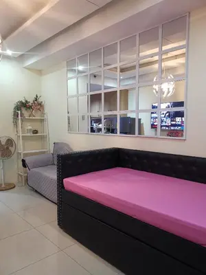 a room with a bed and a couch at 352B Shell Residences Barkada Room in Manila