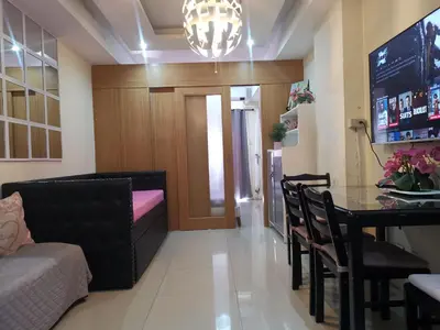 a living room with a table and a couch at 352B Shell Residences Barkada Room in Manila
