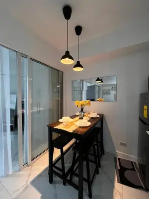a dining room with a table with flowers on it at SM Bicutan Boracay Tower in Manila