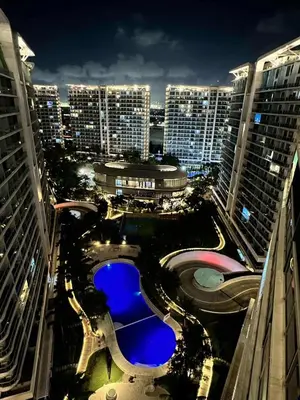 an aerial view of a city at night with buildings at SM Bicutan Boracay Tower in Manila