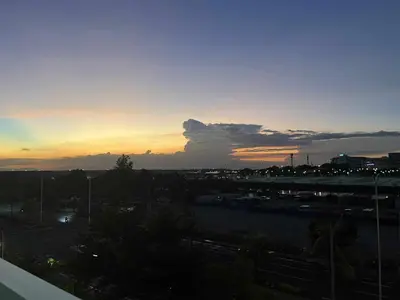 a sunset view of a city with a parking lot at Manila Staycation walking distance to Mall of Asia and near Manila Airport in Manila