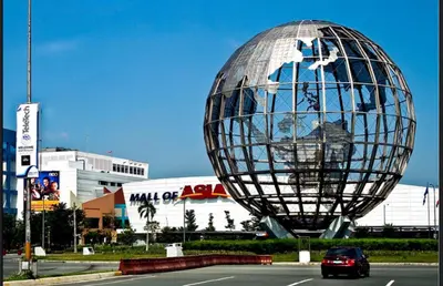 a large metal sphere sitting on the side of a road at Manila Staycation walking distance to Mall of Asia and near Manila Airport in Manila