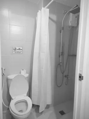 a bathroom with a toilet and a shower with a shower curtain at Condotel or apartment SM JAZZ RESIDENCES in Manila