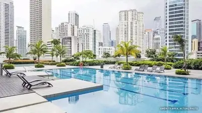a large swimming pool in a city with tall buildings at Condotel or apartment SM JAZZ RESIDENCES in Manila