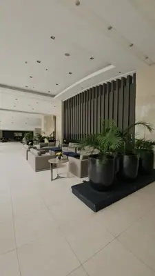 a lobby with couches and potted plants at Cathys Haven Urban Escape in MOA in Manila