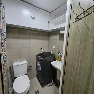 a small bathroom with a toilet and a sink at Cathys Haven Urban Escape in MOA in Manila