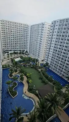 an aerial view of a resort with palm trees and buildings at Cathys Haven Urban Escape in MOA in Manila