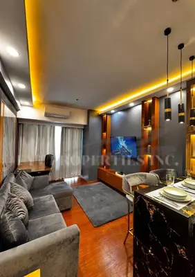 a living room with a couch and a table at Modern Comfort at MOA Shore 3 in Manila