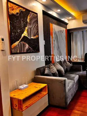 a living room with a couch and a table at Modern Comfort at MOA Shore 3 in Manila