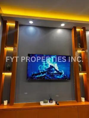 a flat screen tv sitting on top of a wall at Modern Comfort at MOA Shore 3 in Manila