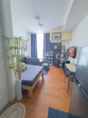a living room with a couch and a table at You Have VIN Here in Manila