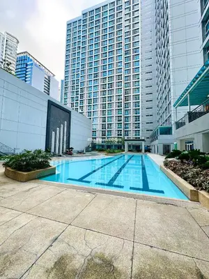 a large swimming pool in a city with tall buildings at You Have VIN Here in Manila