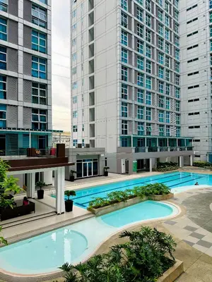 an overhead view of a swimming pool with tall buildings at You Have VIN Here in Manila