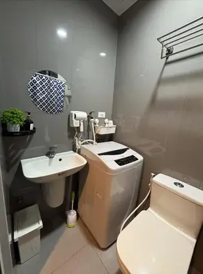 a bathroom with a toilet and a sink at Solace Haven in Manila