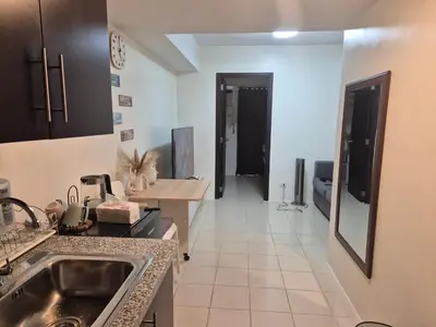 a kitchen with a sink and a counter at Kasara Urban Resort Elly's Pad with balcony in Manila
