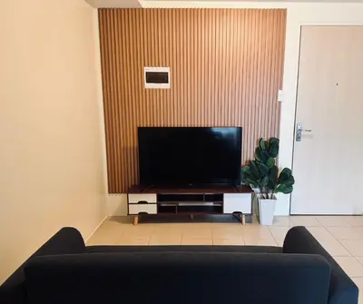 a living room with a couch and a flat screen tv at Danny's Haven Ortigas in Manila