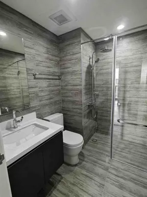 a bathroom with a toilet and a sink and a shower at Luxury Condo at Century Spire in Central Makati in Manila