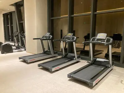a row of tread machines in a gym at Luxury Condo at Century Spire in Central Makati in Manila