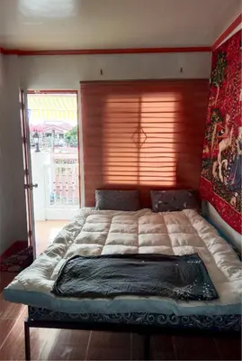 a large bed in a bedroom with a window at Your Little Resort, calm, secure in Manila