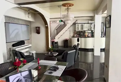a living room with a table and chairs at Your Little Resort, calm, secure in Manila