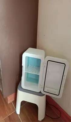 a small white microwave sitting on a stool at Your Little Resort, calm, secure in Manila