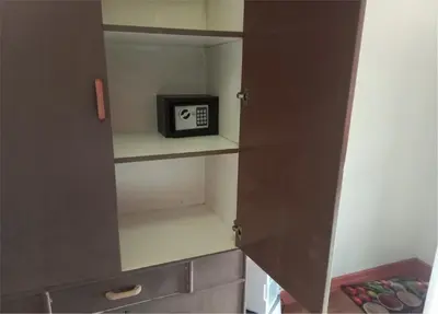 a small cabinet with a clock on it in a kitchen at Your Little Resort, calm, secure in Manila